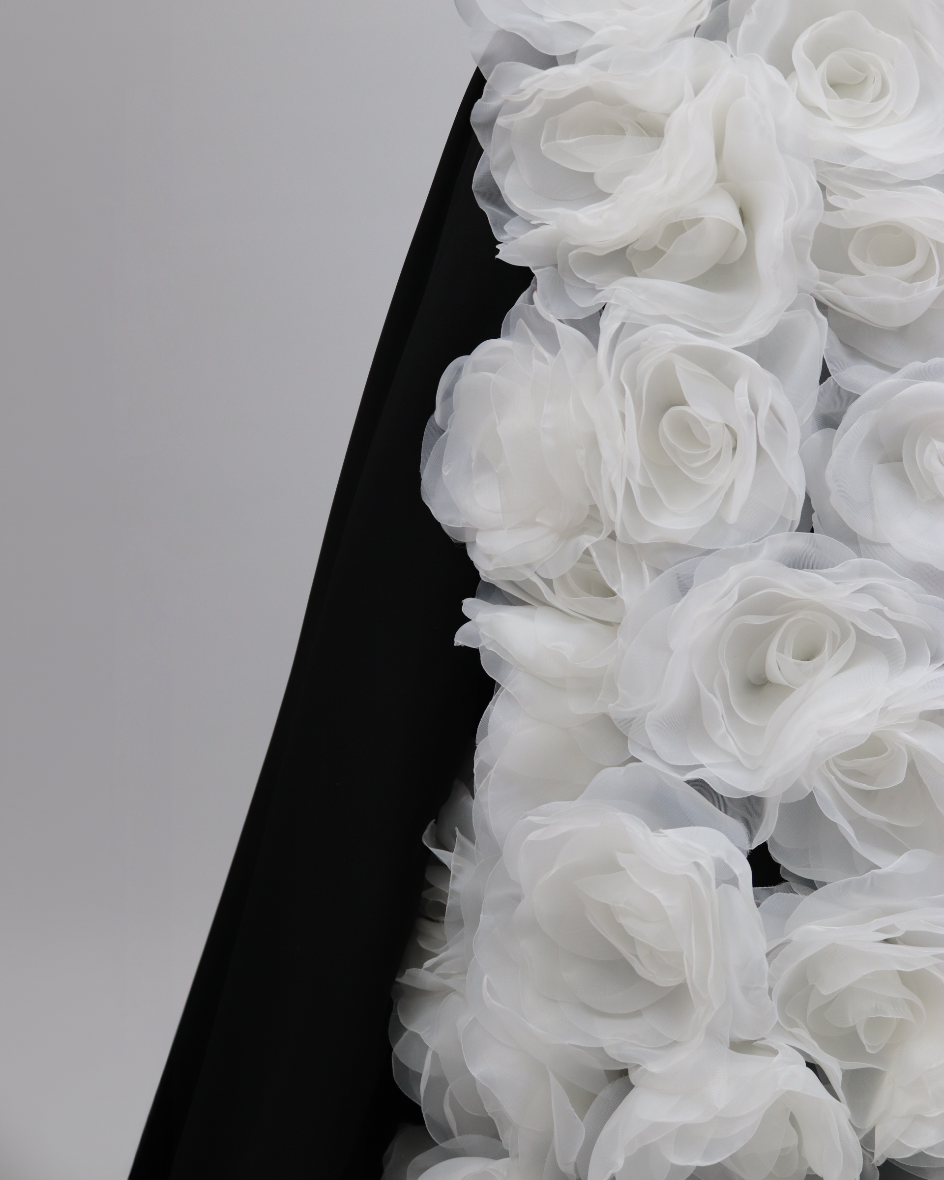 Strapless black dress with 3D flowers and a train
