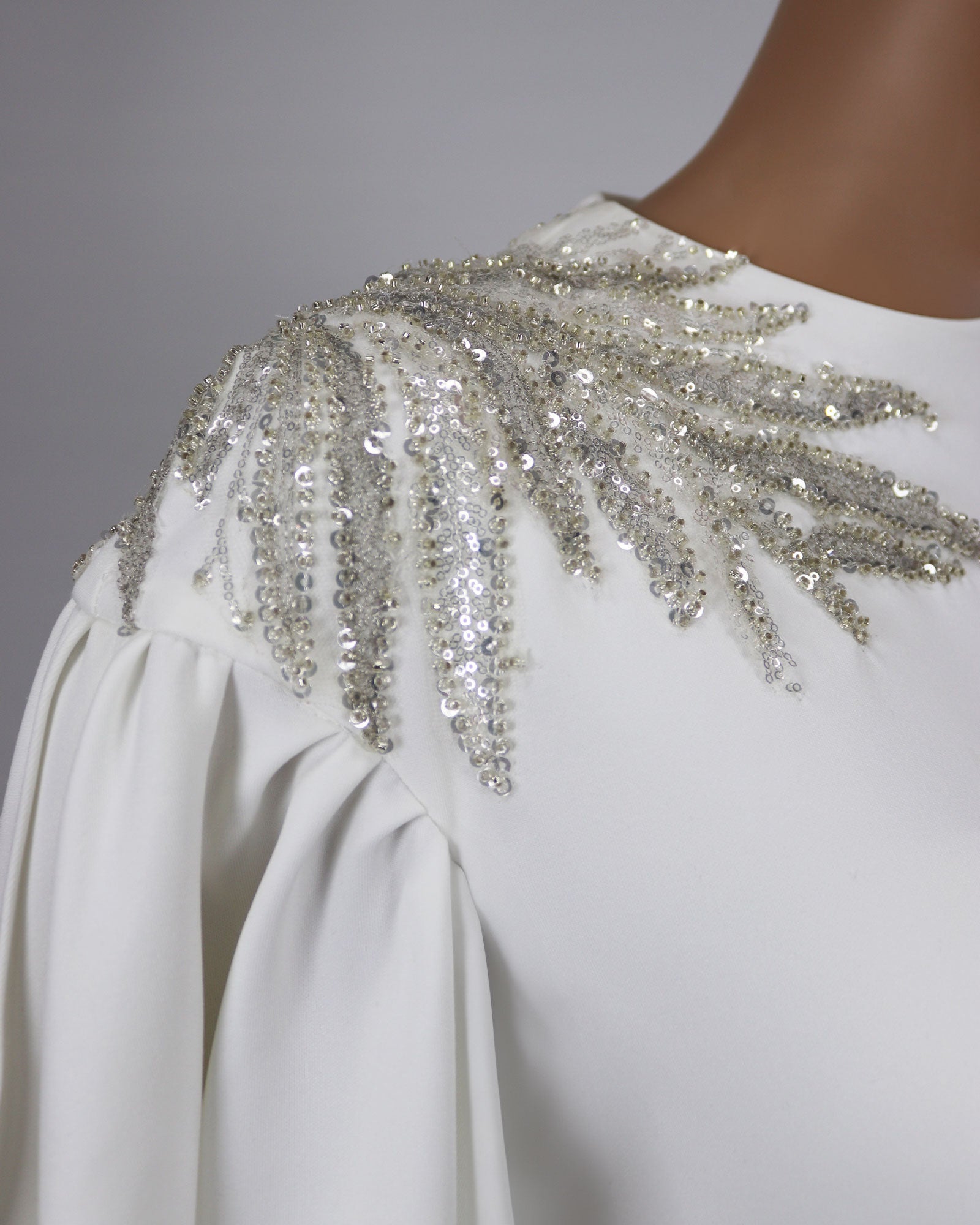 White column dress with ruffled sleeves and sequined shoulders