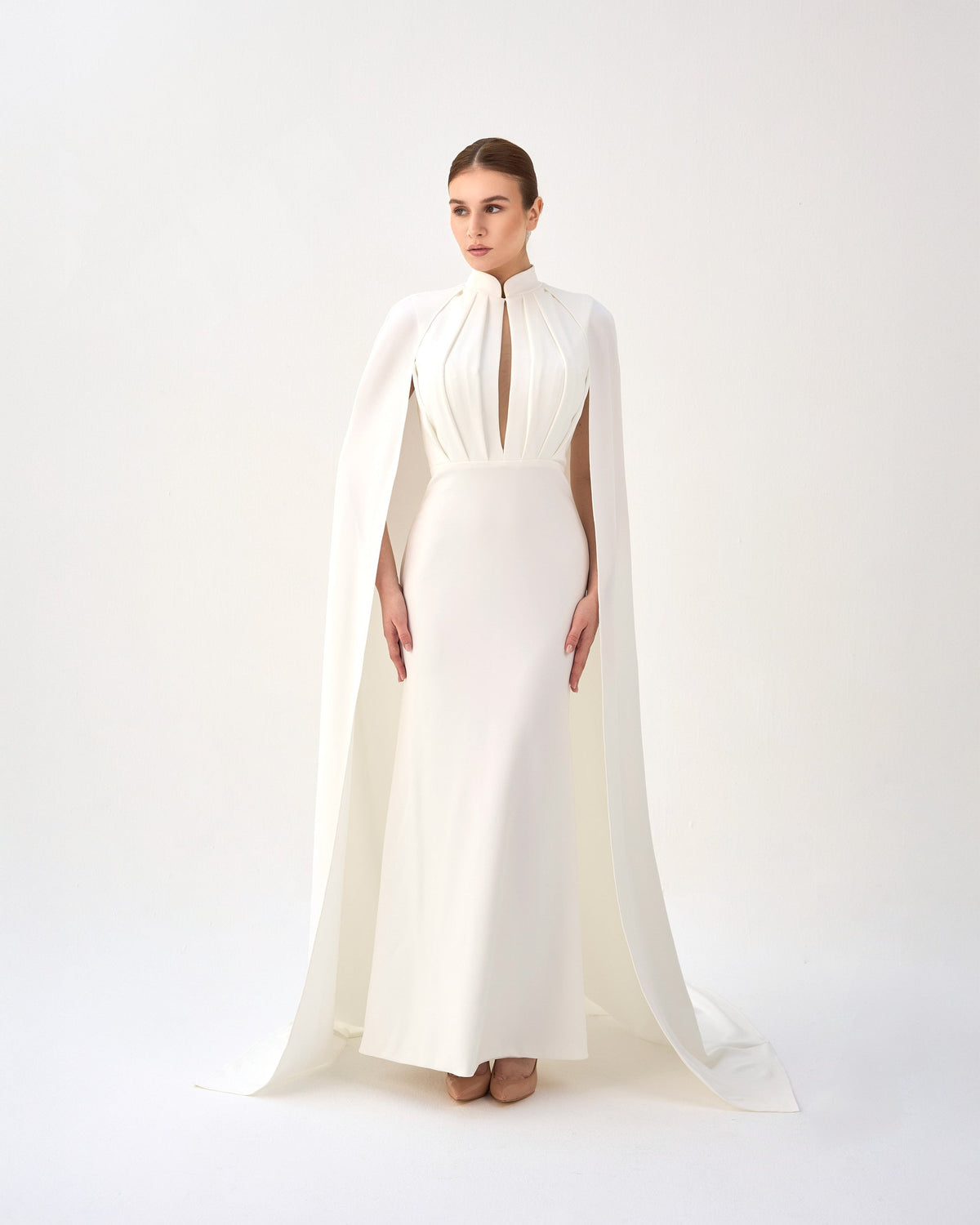 White pleated dress with neckline and cape