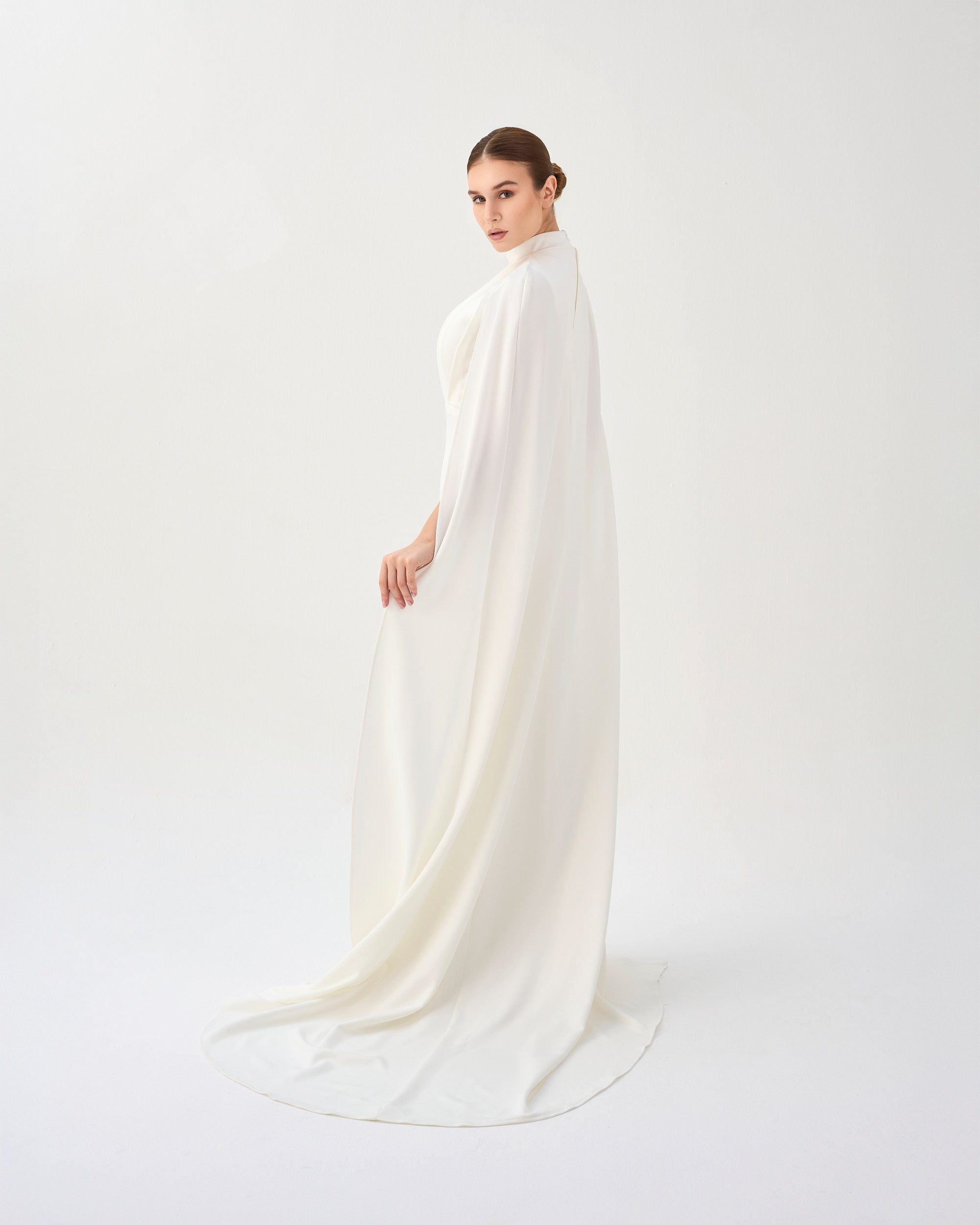 White pleated dress with neckline and cape