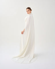 White pleated dress with neckline and cape