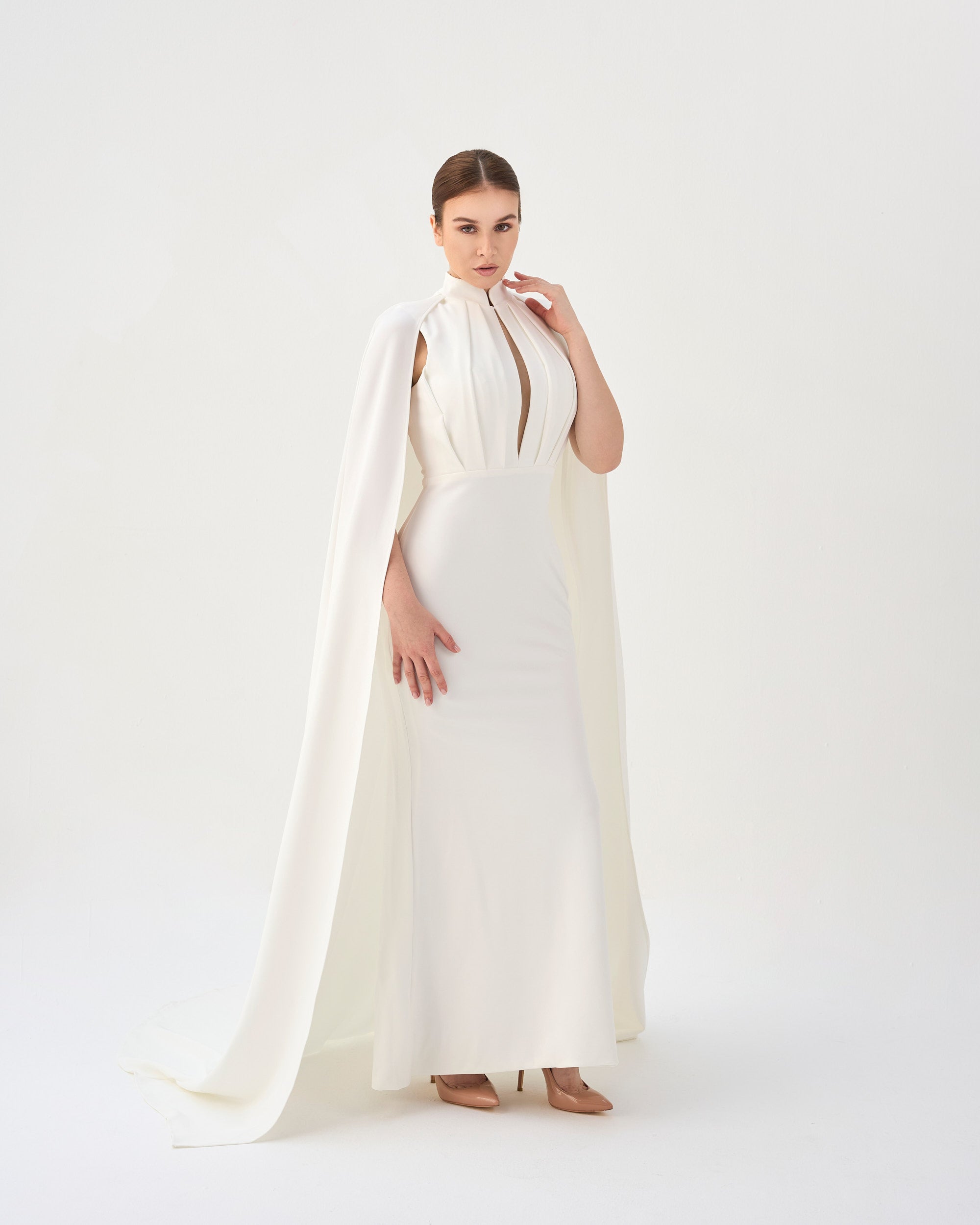 White pleated dress with neckline and cape