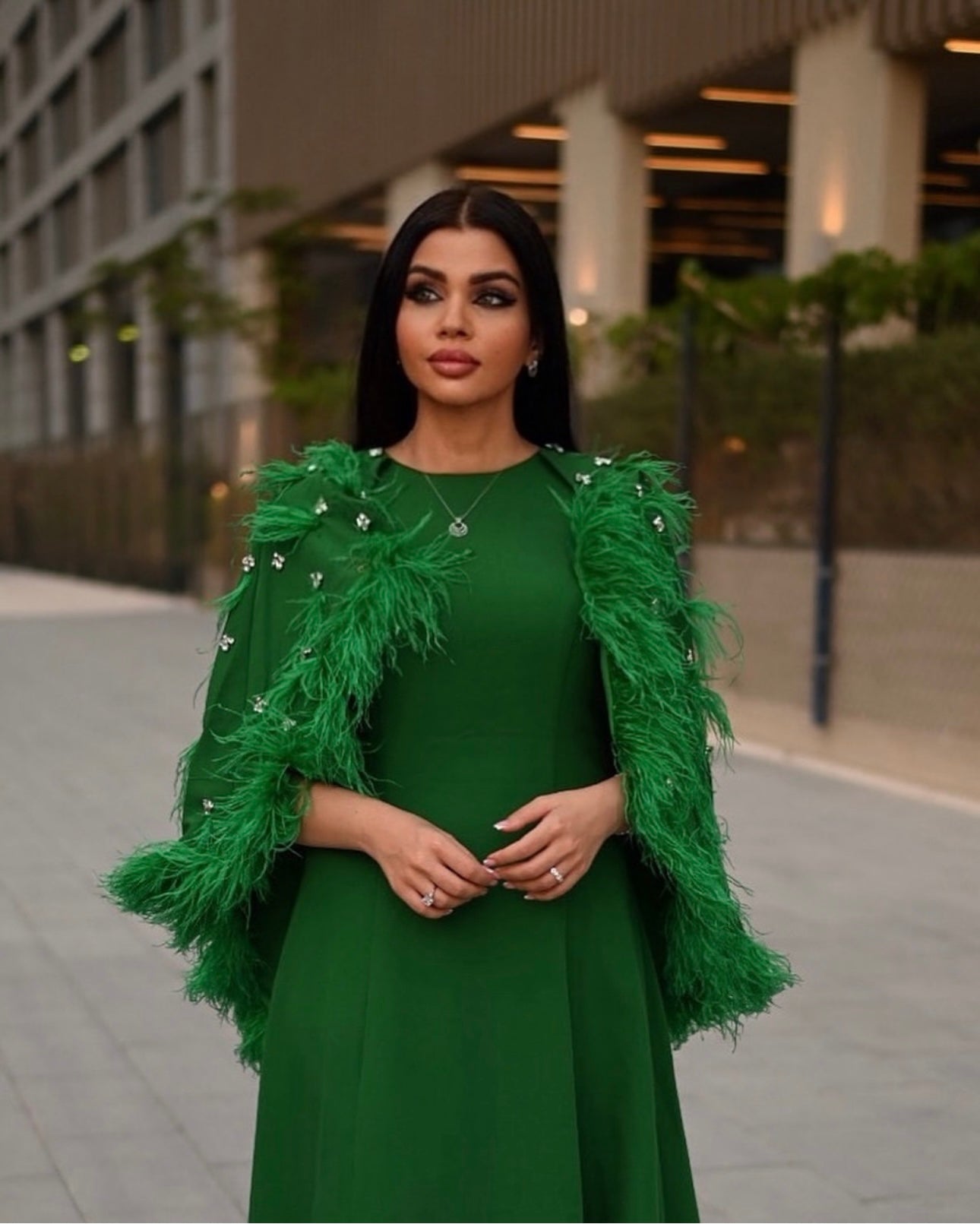 feather-embellished cape gown in emerald – Svadhi