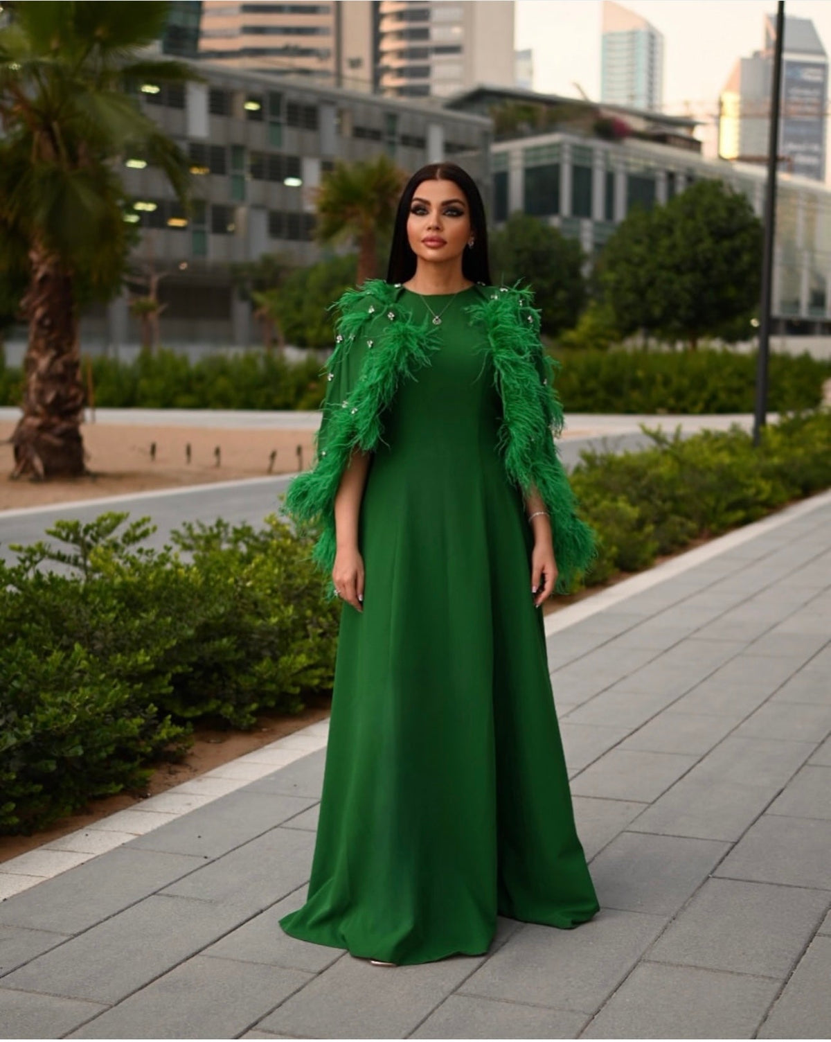feather-embellished cape gown in emerald – Svadhi