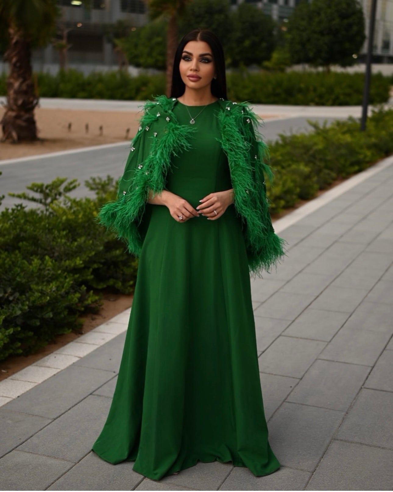 feather-embellished cape gown in emerald – Svadhi
