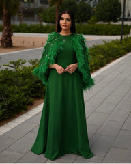 feather-embellished cape gown in emerald – Svadhi