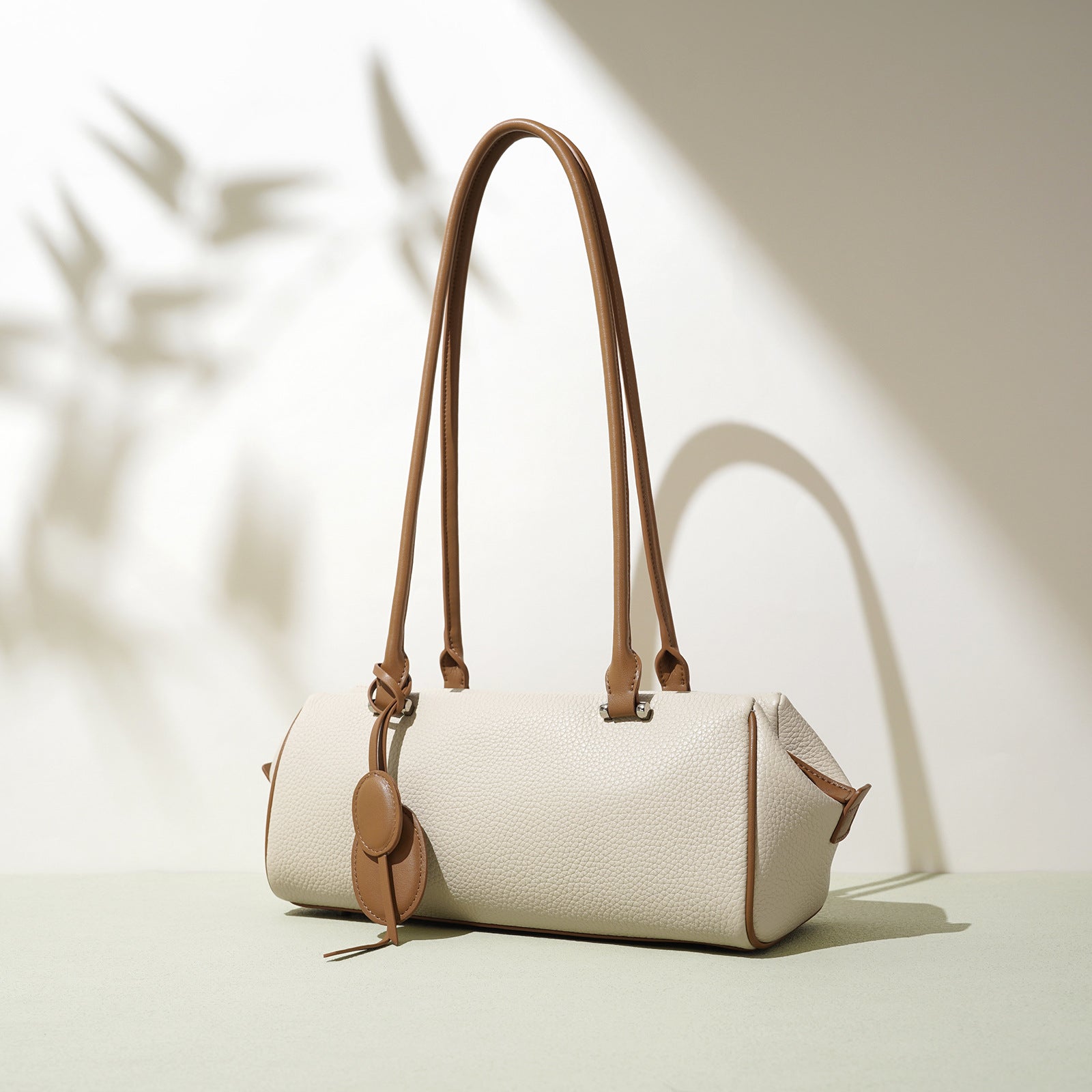 barrel-shaped shoulder bag with twin charm detail – LILURA