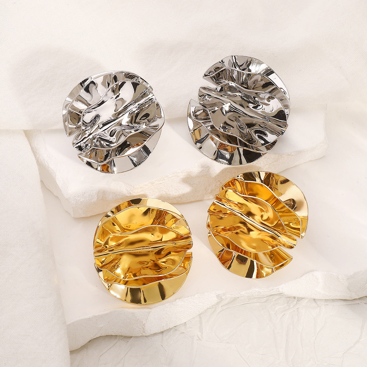round folded metal stud earrings with embossed detail - ORAD
