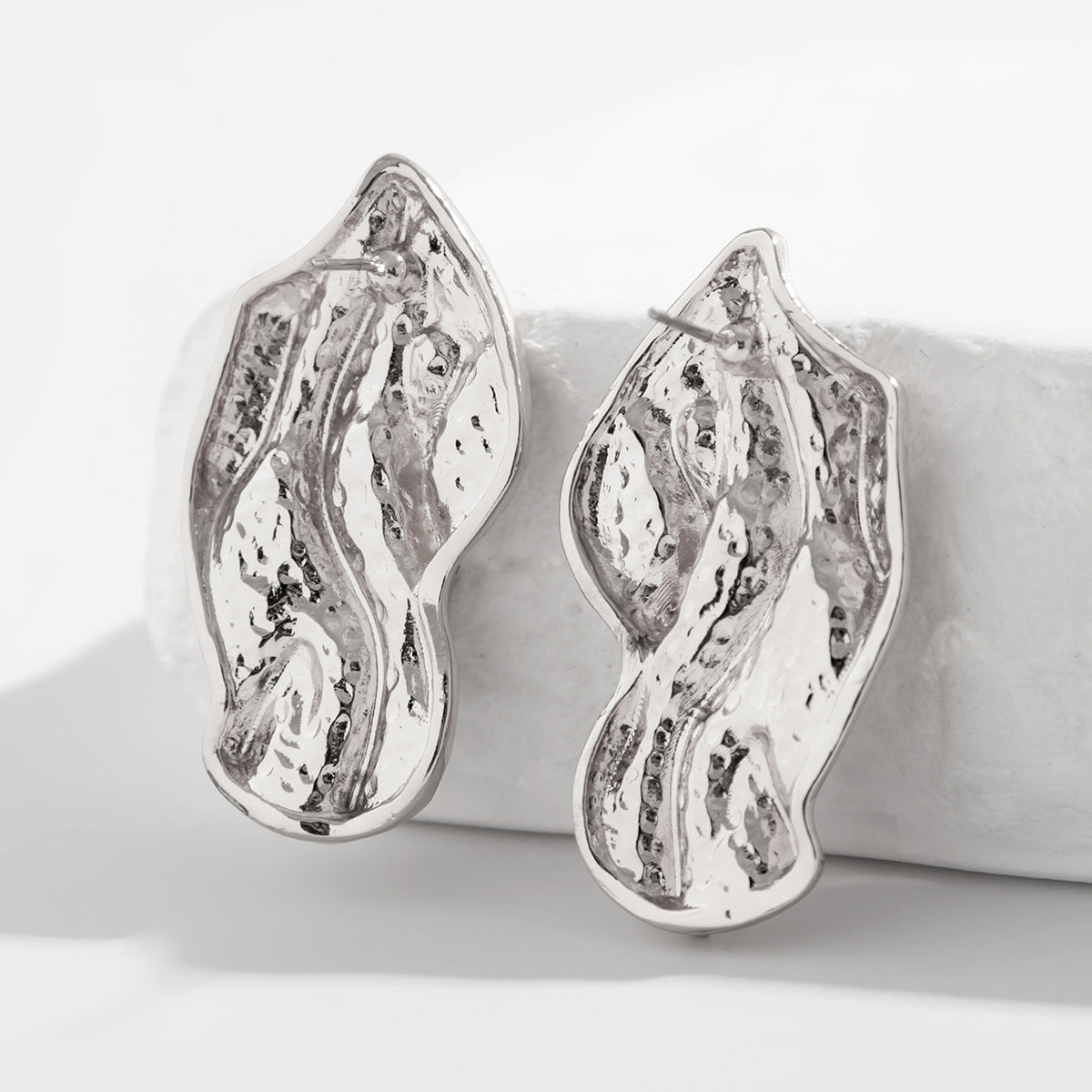 Molten wave stud earrings with organic contours - Roni
