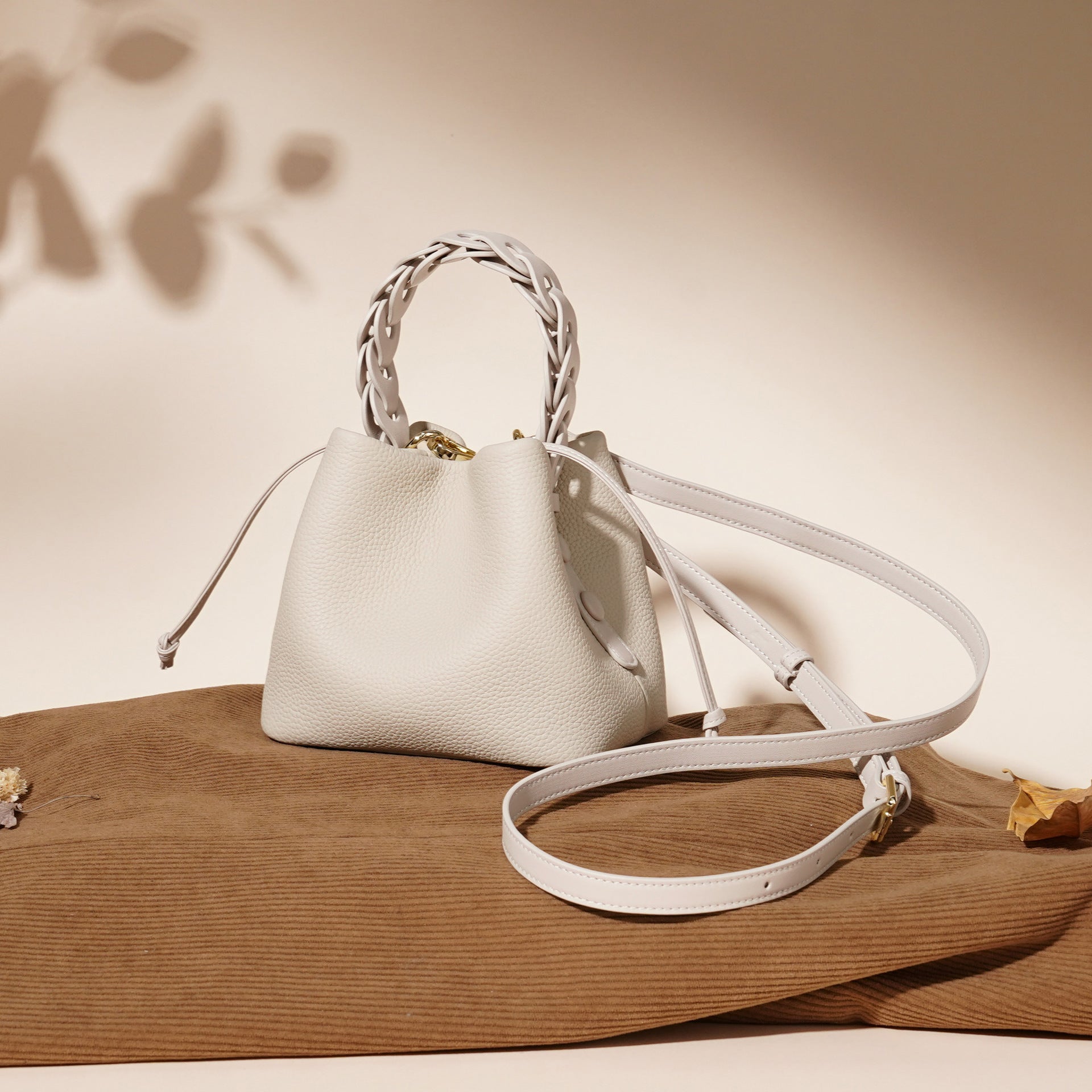 ivory pebbled leather bucket bag with braided top handle – CALISTA