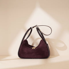 curved suede shoulder bag with gold twist lock – VIOLETTE