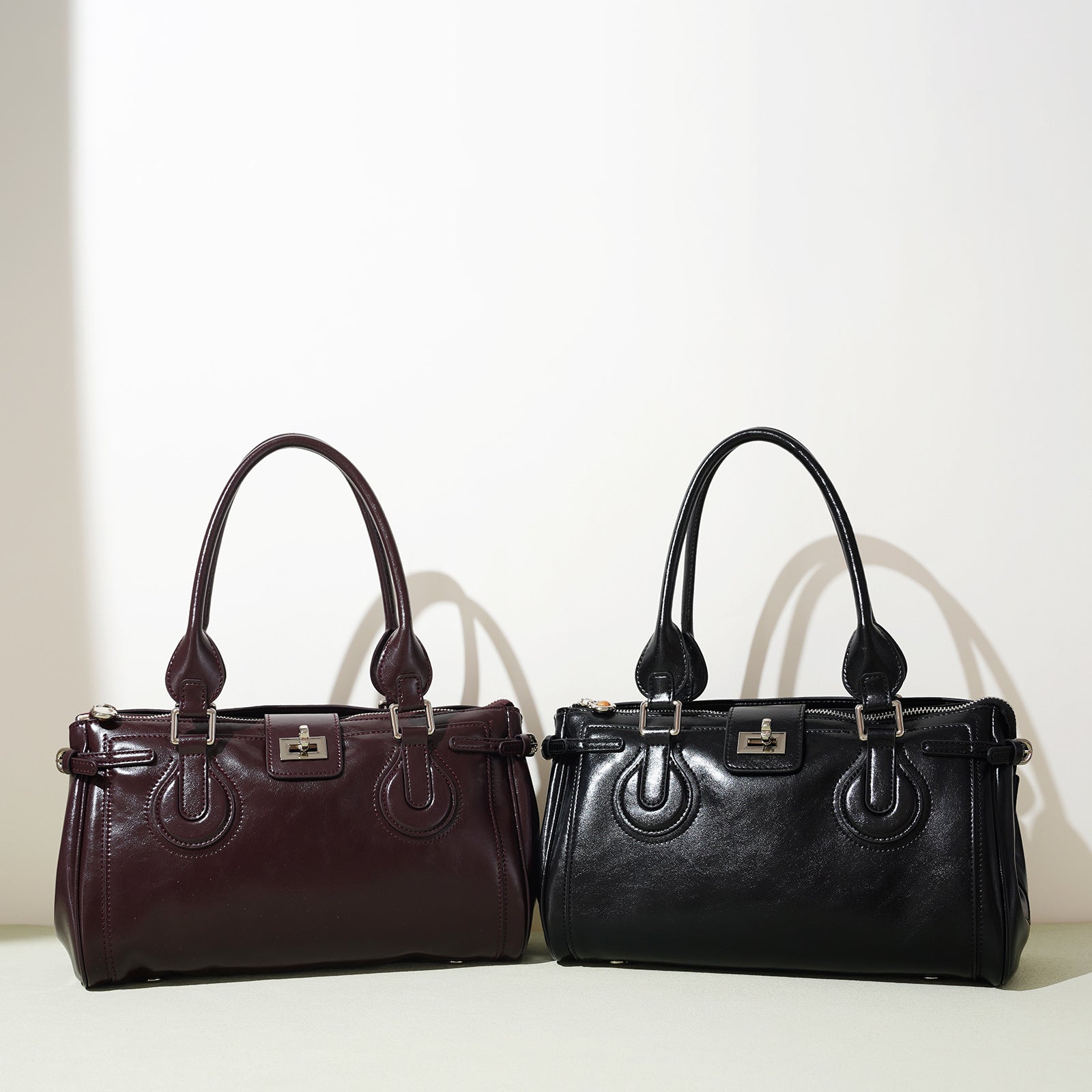 structured patent shoulder bag with buckle detail - AMIRDA