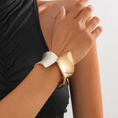 Two-tone wide cuff bracelet with sculptural twist - Nesdu
