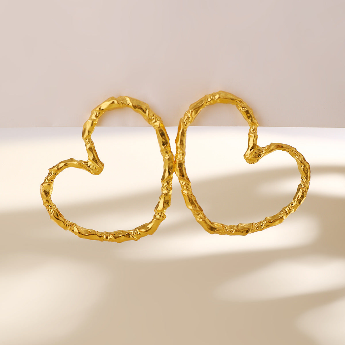 textured heart hoop earrings in matte gold – AMORA