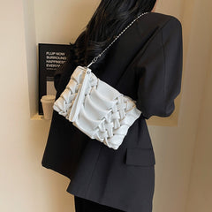 woven clutch with sculpted leather detail – FAYE