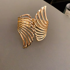 cutout flame cuff bracelet in polished gold – NYRIA