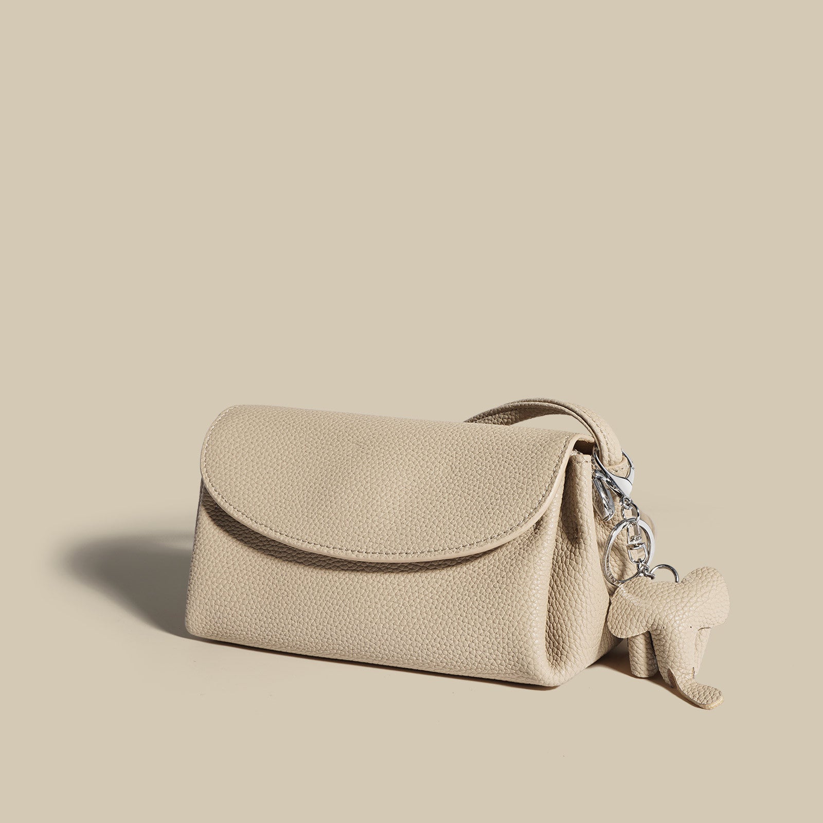 textured flap crossbody bag with elephant charm - NOMA