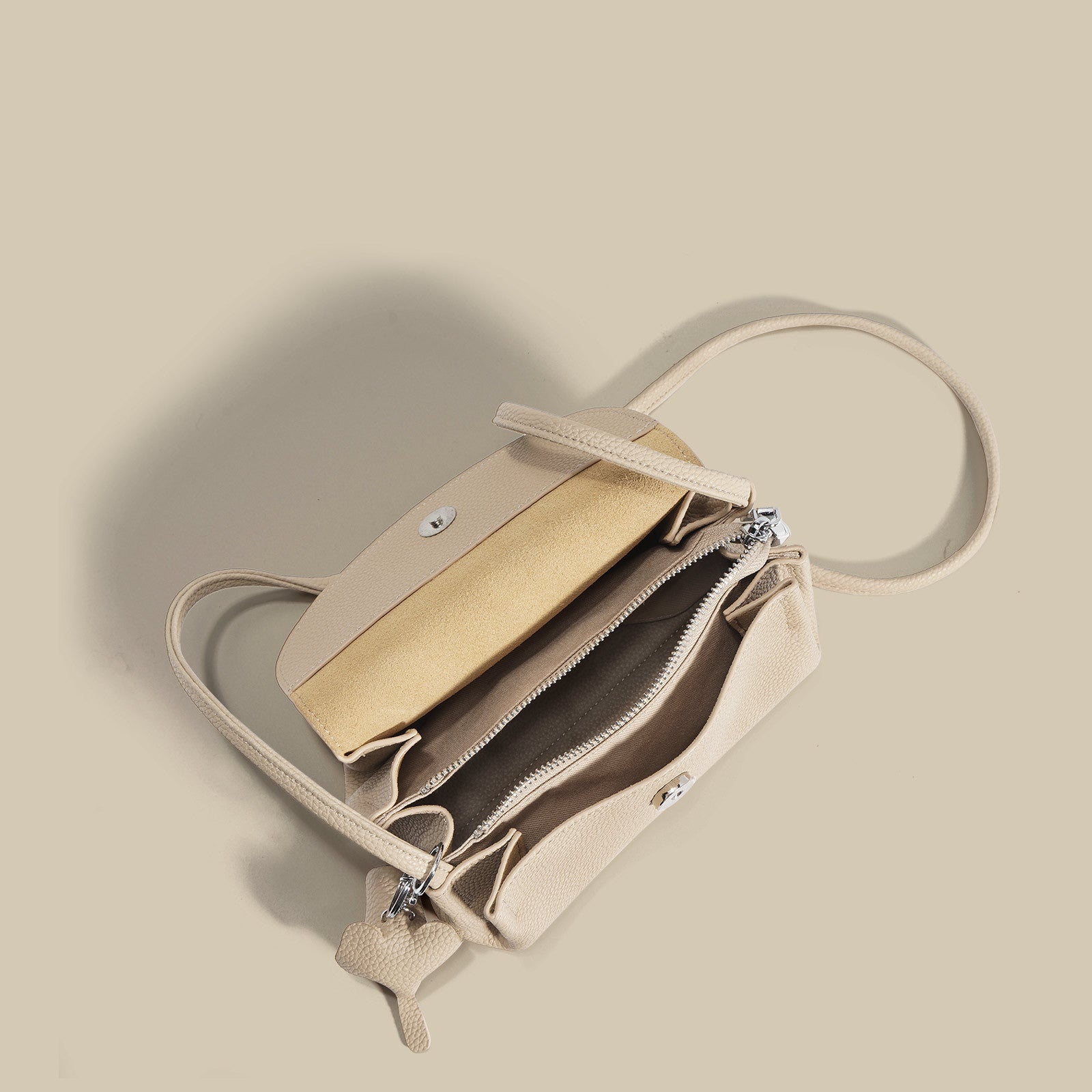 textured flap crossbody bag with elephant charm - NOMA