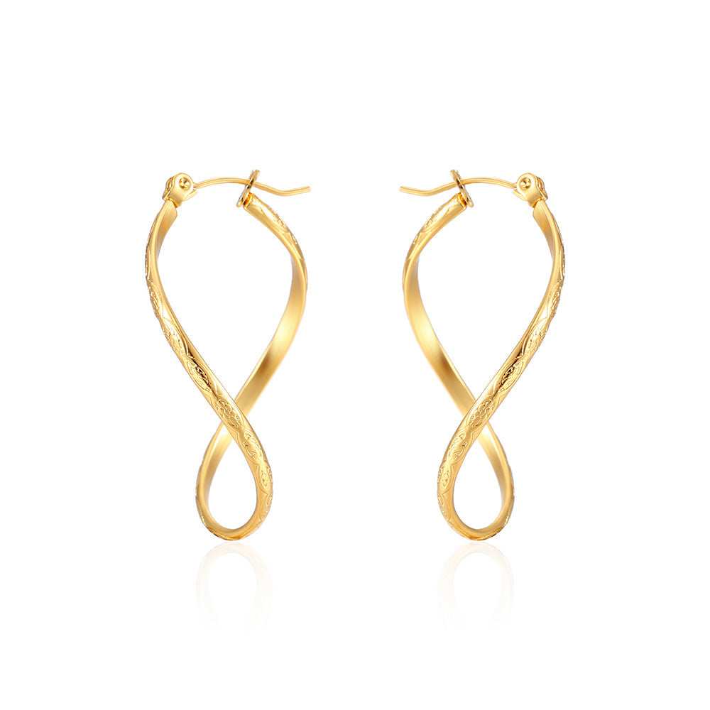 Twisted infinity hoop earrings with engraved detail - Solida