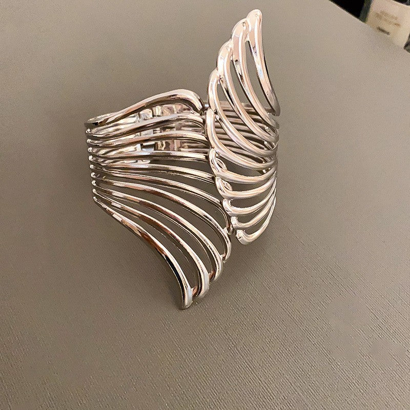 cutout flame cuff bracelet in polished gold – NYRIA