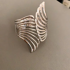 cutout flame cuff bracelet in polished gold – NYRIA