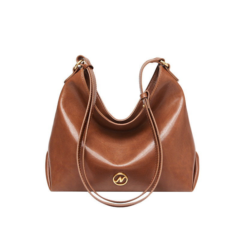 slouchy leather shoulder bag with gold emblem – AURX