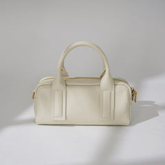 structured mini barrel bag in polished black – VERN
