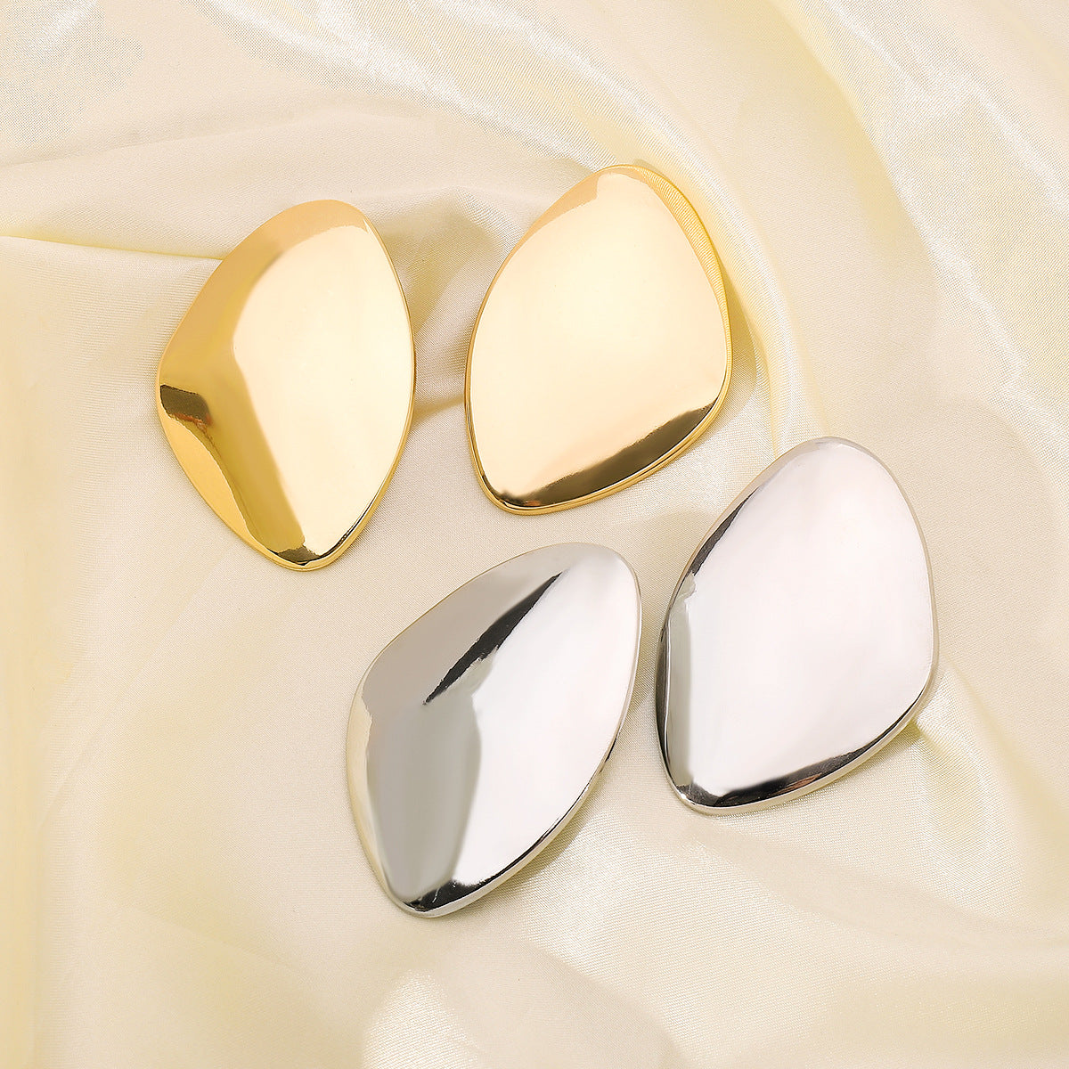 Asymmetric leaf-shaped metal earring with high polish finish – Elindu