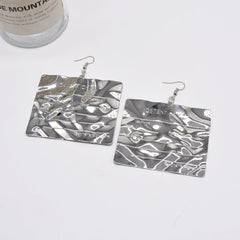 Engraved metallic statement earrings with hammered texture - Lanai