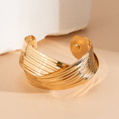 layered gold cuff bracelet with twisted band design – SEREIA