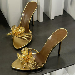 black stiletto mules with gold sculpted flower – CALISTA