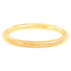 sleek coiled metal bangle with gold finish – ALVINA