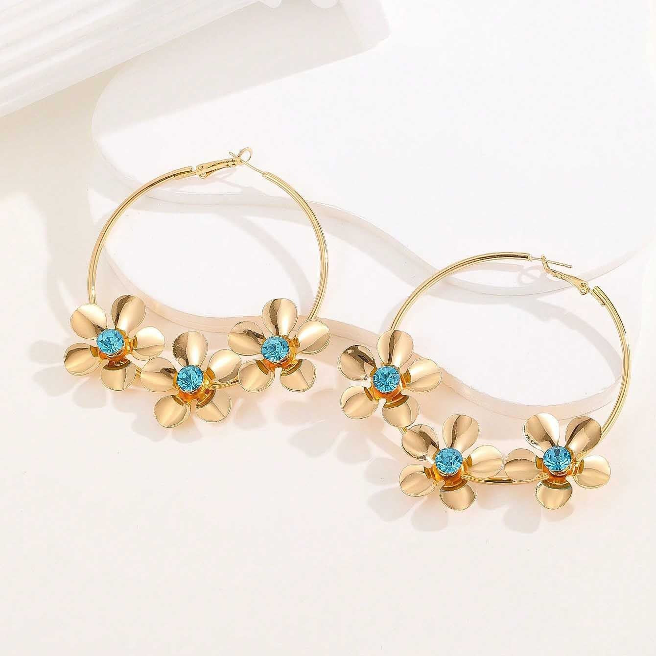floral hoop earring with blue crystal centers – AURELIA