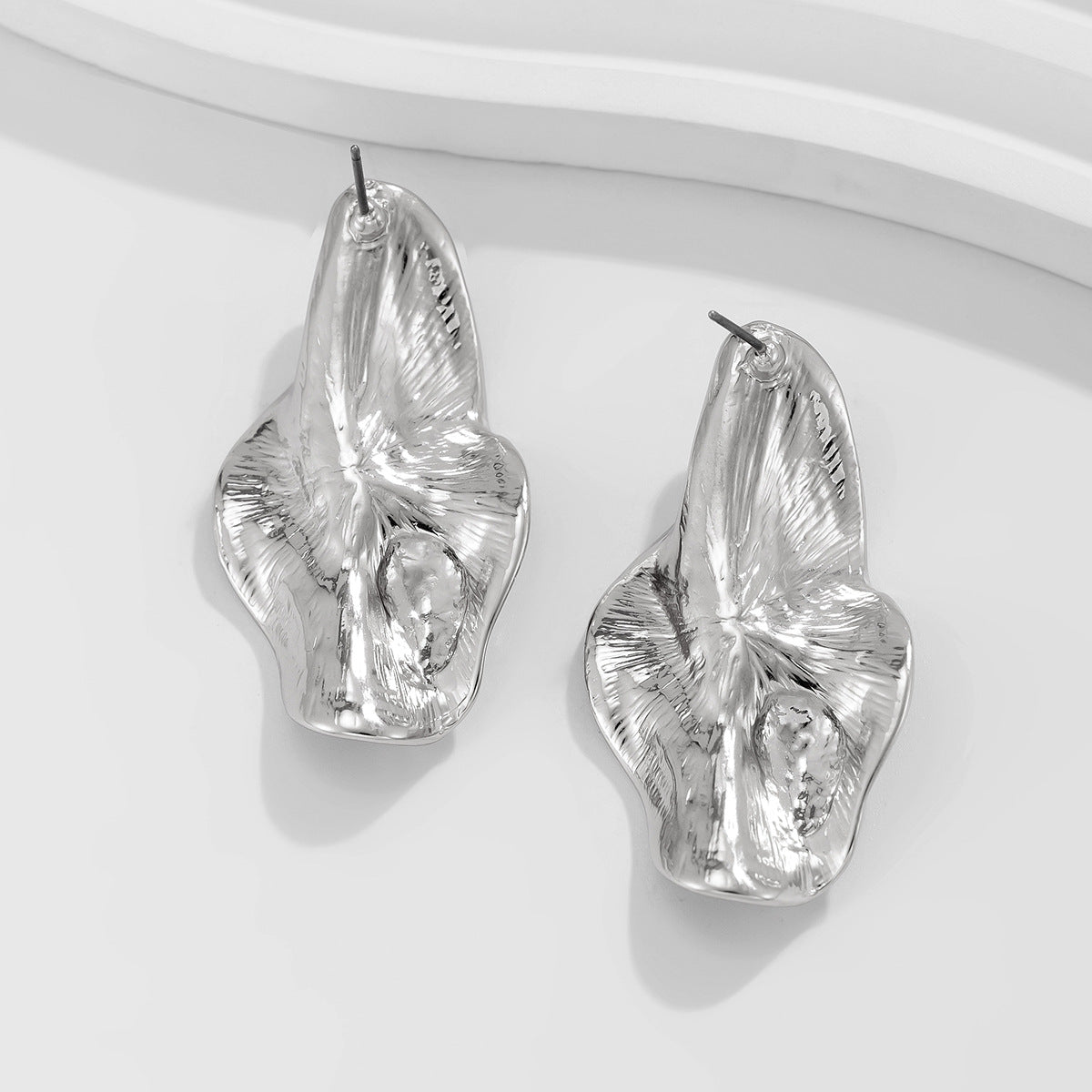 abstract sculpted stud earrings with melted metal finish - Nayam