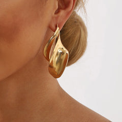 fluid wave drop earrings in polished gold – LUMINA
