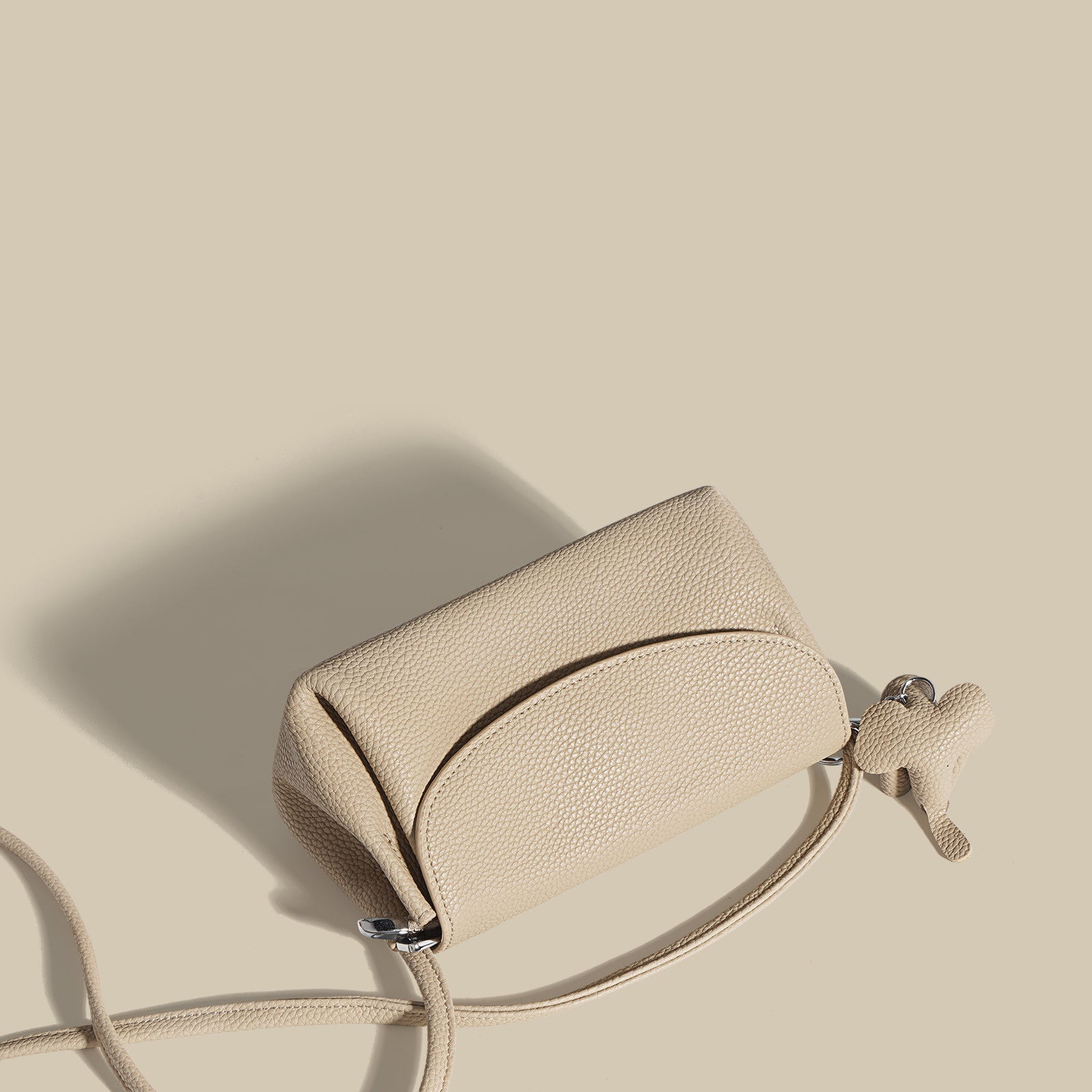 textured flap crossbody bag with elephant charm - NOMA
