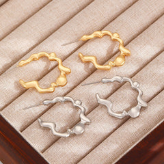 Organic wave hoop earrings with fluid silhouette - Nalma
