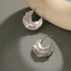 Molten crescent hoop earrings with textured finish – Zolix
