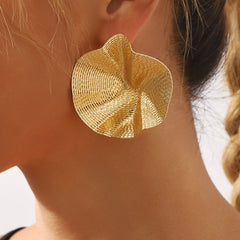 oversized spiral shell earrings in textured gold – LUMINA