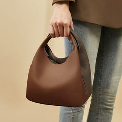 two-tone pebbled leather bucket bag with contrast strap – ARDEN