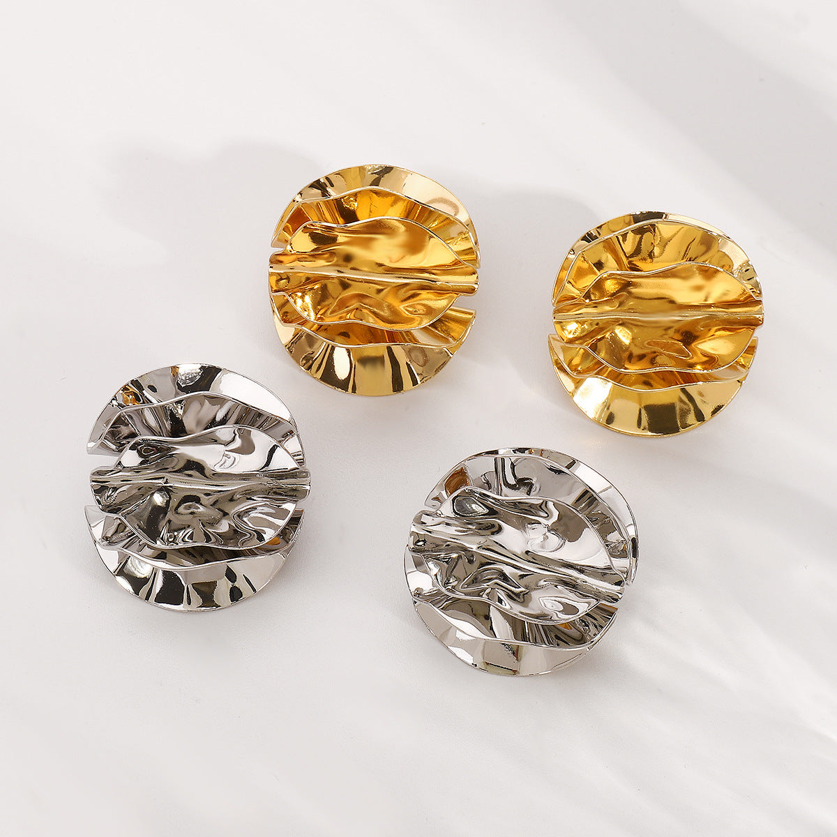 round folded metal stud earrings with embossed detail - ORAD