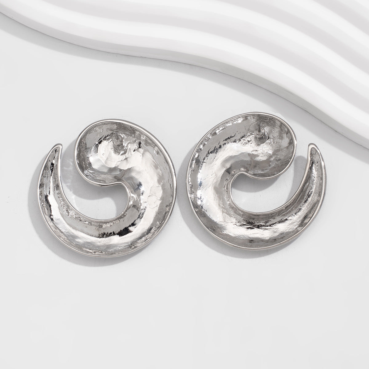 Swirl-shaped stud earrings with glossy finish - Tondi