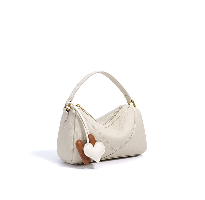 curved shoulder bag with contrast charm detail – MIIRA