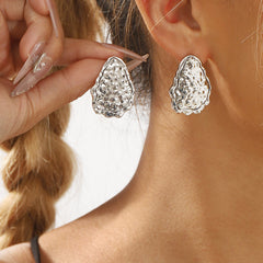 textured oval stud earrings with irregular edge trim - ALMAV