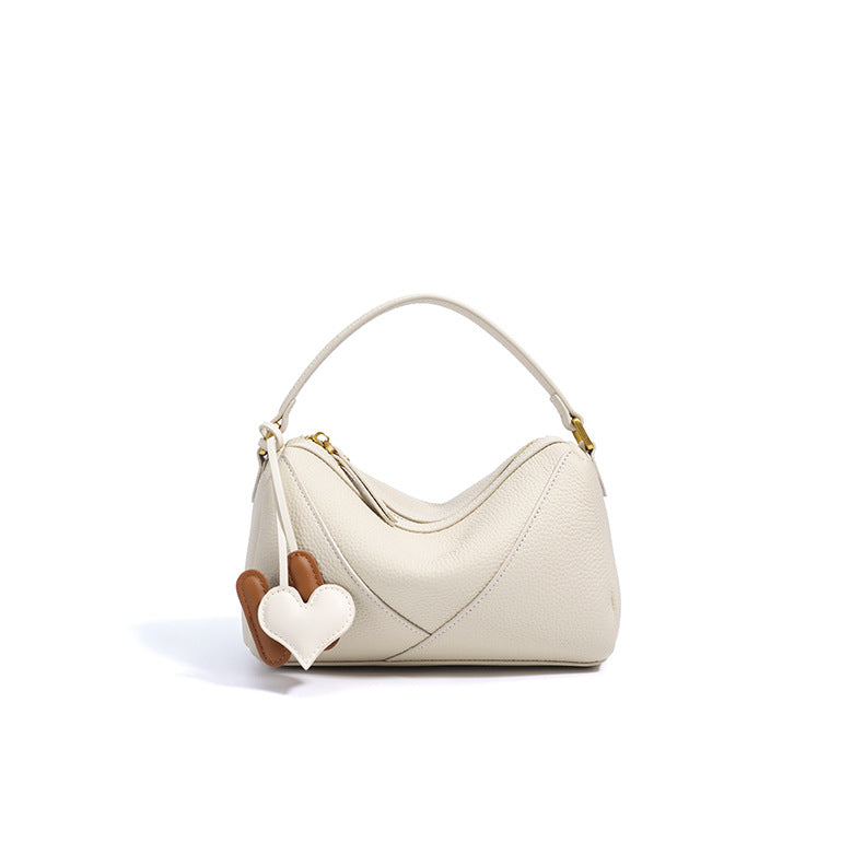 curved shoulder bag with contrast charm detail – MIIRA