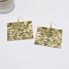 Engraved metallic statement earrings with hammered texture - Lanai