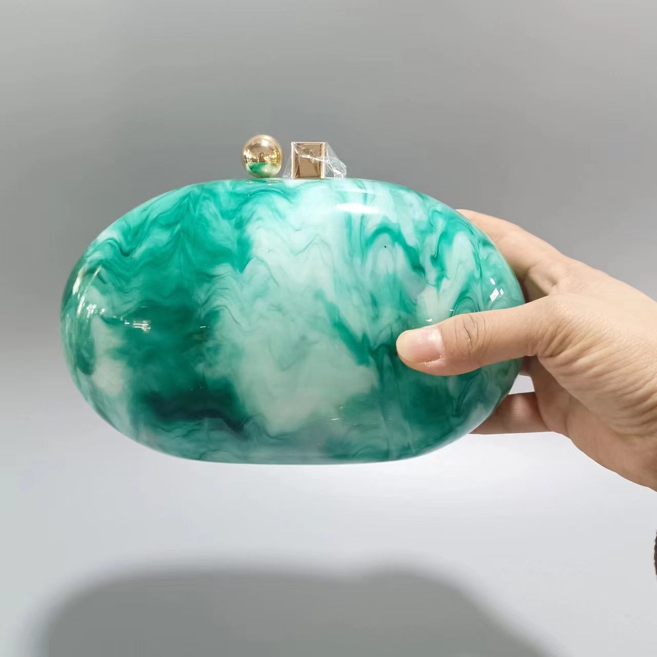 Oval marble clutch with gold clasp and chain handle - Zigru