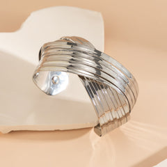 layered gold cuff bracelet with twisted band design – SEREIA