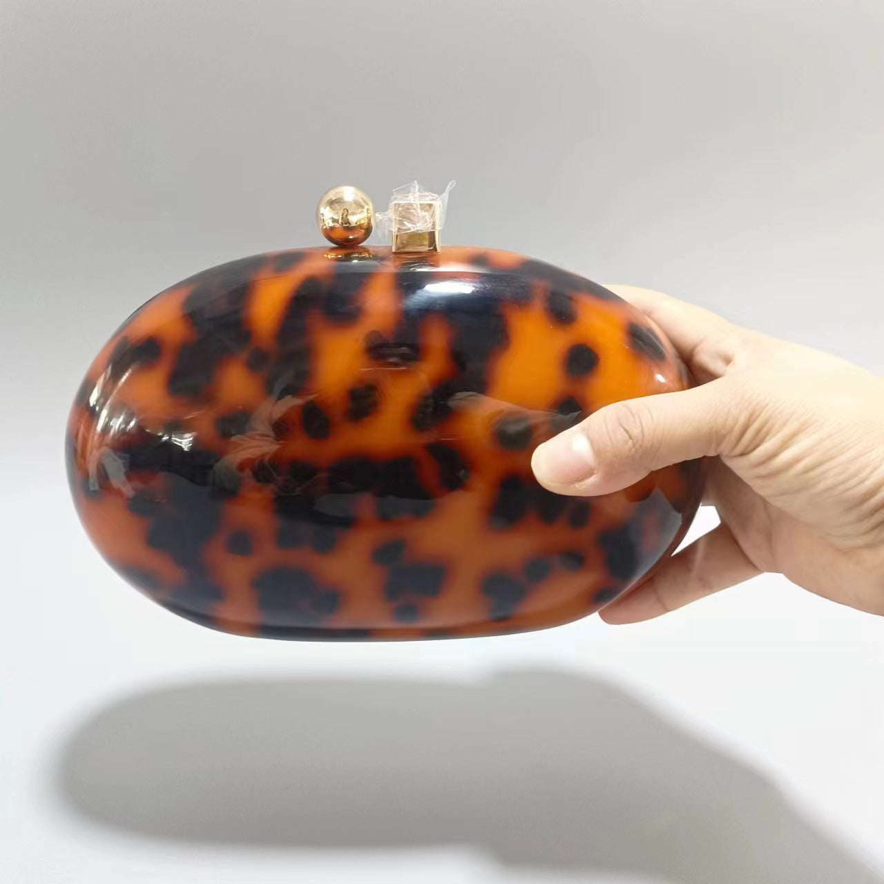 Oval marble clutch with gold clasp and chain handle - Zigru