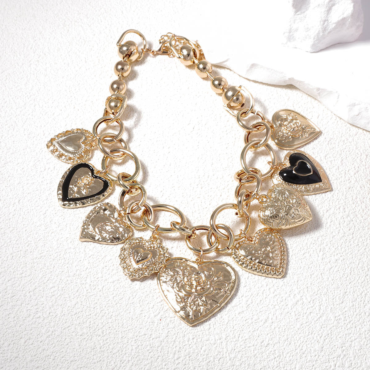 Gold-tone charm necklace with embossed heart pendants - Alginu